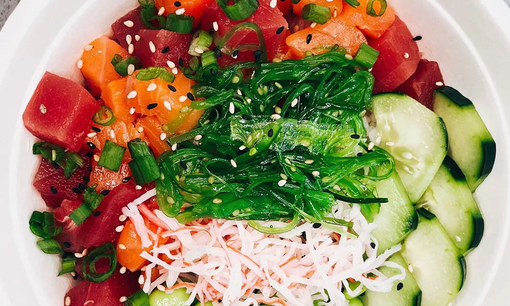 Fresh tuna/salmon poke bowl with seaweed, cucumber at Hau'oli Poke Burritos & Bowls, a Japanese Restaurant in Sherman
